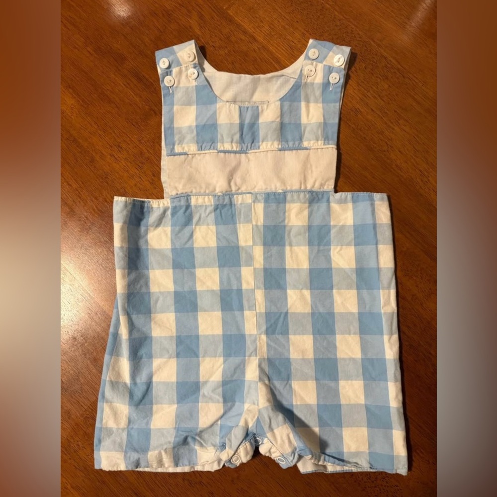 Baby boy blue smocked romper by the brand Smockingbird